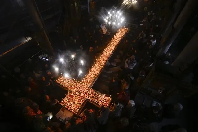 Believers light candles on honey jars for Saint Haralampi at Bulgarian church