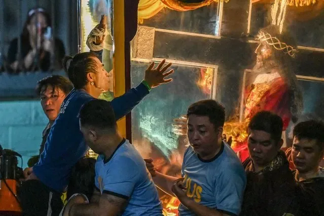 Catholic devotee kisses carriage during annual Black Nazarene religious procession in Manila Philippines