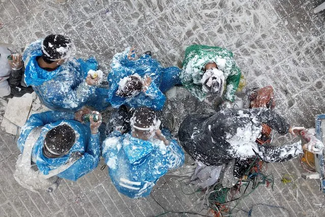 People covered in soap foam parade at Blacks and Whites carnival in Pasto Colombia 2025