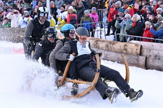 Competitors race wooden sledges in the traditional Bavarian Hornschlittenrennen in Garmisch-Partenkirchen Germany