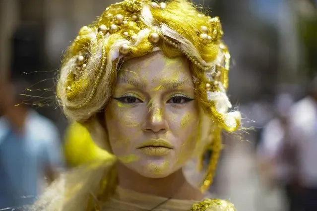 Actress representing gift of gold poses at Epiphany pre-event in Plaza de Armas Santiago Chile