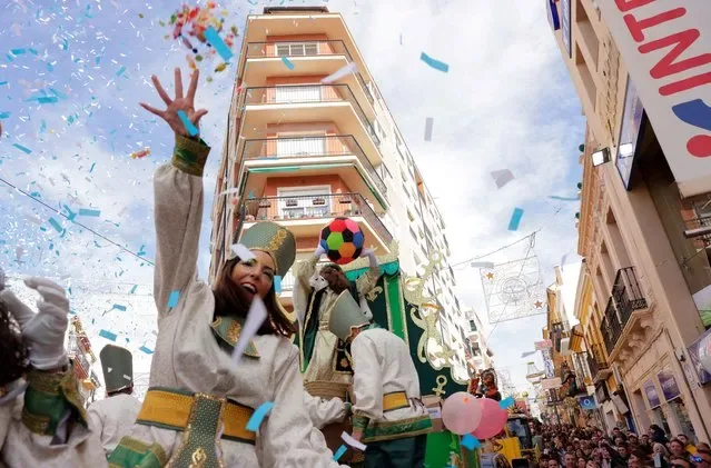 Diego Sanchez dressed as Gaspar throws sweets from float during Epiphany parade in Ronda Spain