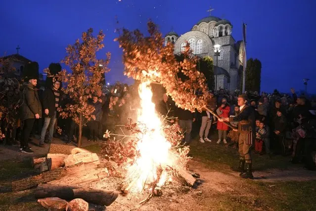 Orthodox Christians burn oak Yule log branches outside St Luke church in Belgrade Serbia January 2025