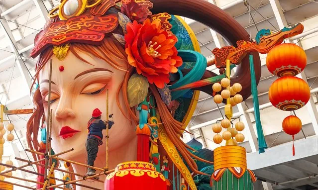 Worker installs giant traditional Chinese lantern in Qingdao for Year of the Snake celebrations