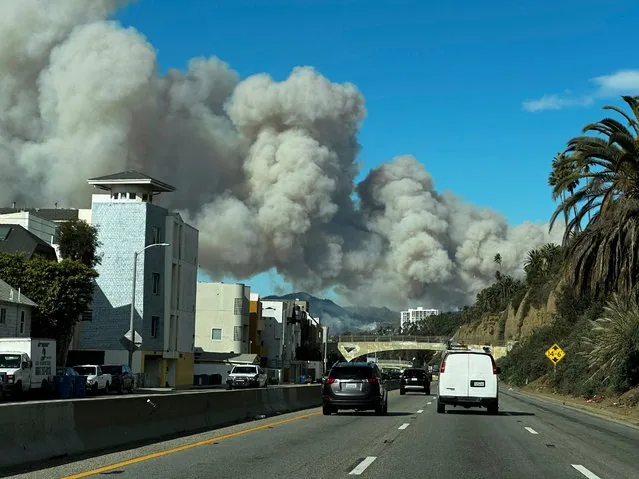 Thick smoke from Pacific Palisades brush fire rises above Pacific Coast Highway Santa Monica California