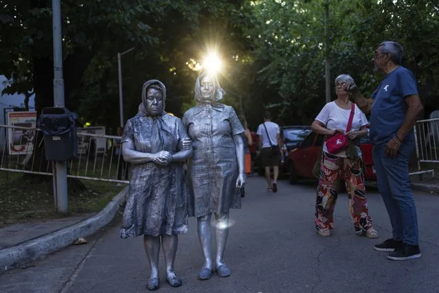 Women dressed as Mothers of Plaza protest Milei government layoffs at Buenos Aires cultural center
