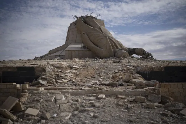 Destroyed statue of late Syrian President Hafez Assad on a mountaintop in Dayr Atiyah Syria