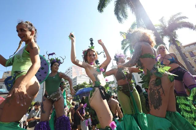 Stilt-walking reveler performing at unofficial Rio Carnival kickoff with Bloco Planta na Mente