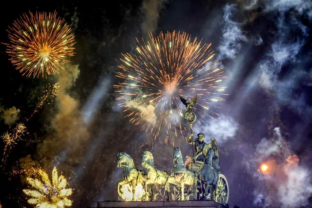 Fireworks illuminating Brandenburg Gate Quadriga during Berlin New Year celebrations 2025