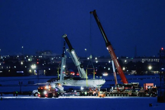 Delta Air Lines CRJ900 wreckage being hoisted at Toronto Pearson International Airport