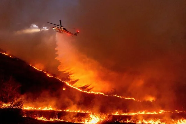 Helicopter drops water on Kenneth Fire in West Hills Los Angeles January 2025