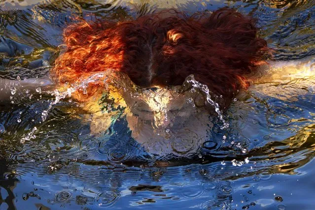 Woman plunges into icy water celebrating Orthodox Epiphany Stroginskaya floodplain Moscow Russia