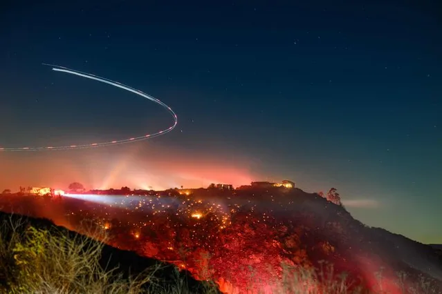 Long exposure photo of helicopter surveying Lilac fire in San Diego County California January 2025