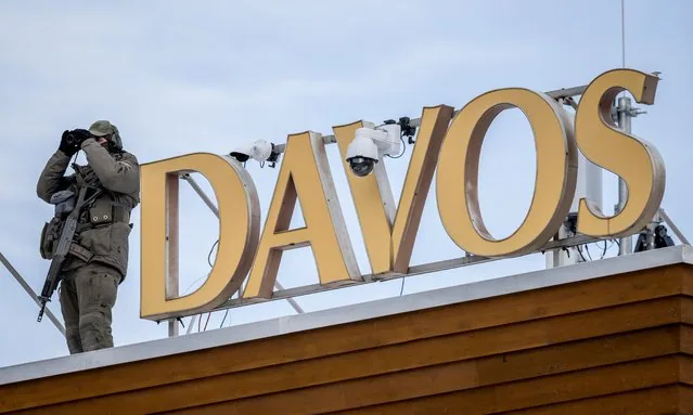 Sniper police officer on Congress hotel rooftop during World Economic Forum Davos 2025