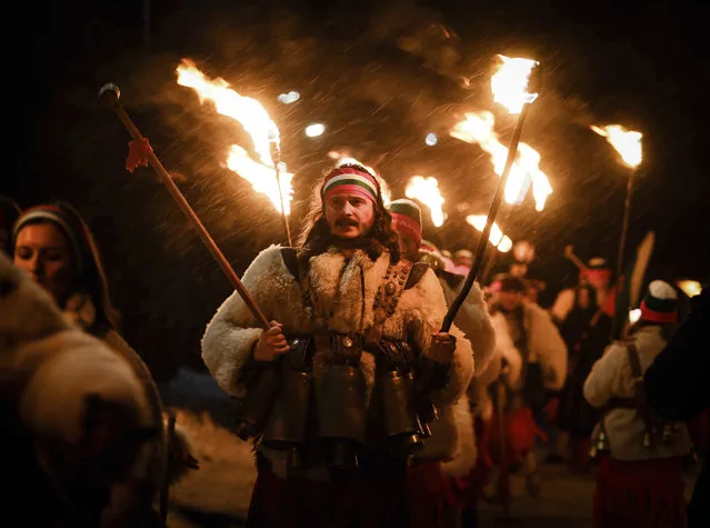 Bulgarian kukeri dancers perform Surva ritual with torches bells and masks village Svetlya January 2025