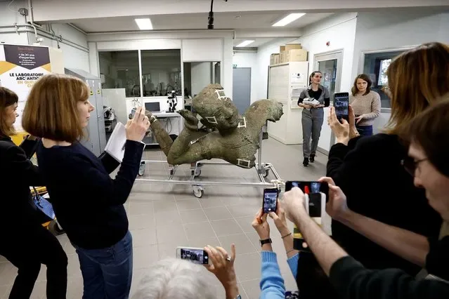 Journalists photograph Reclining Vishnu bronze statue at Arc Antique laboratory Nantes