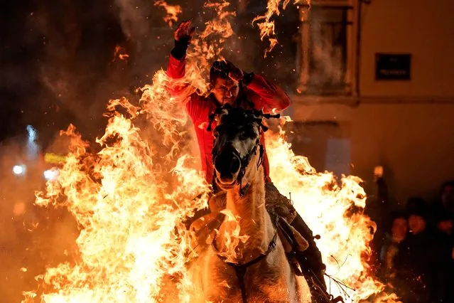 Horseman rides through flames at Luminarias celebration San Bartolome de Pinares Spain