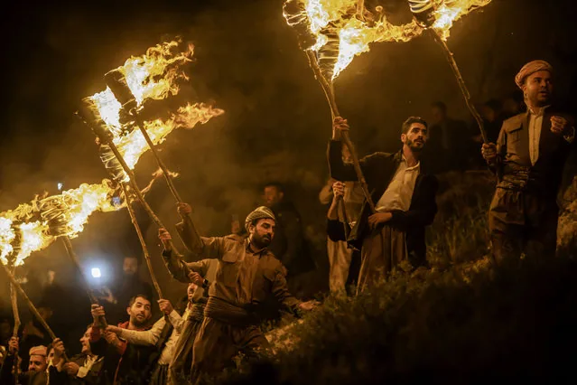 Iraqi Kurds carrying torches to celebrate Nowruz in Akre district Nineveh Iraq March 2025