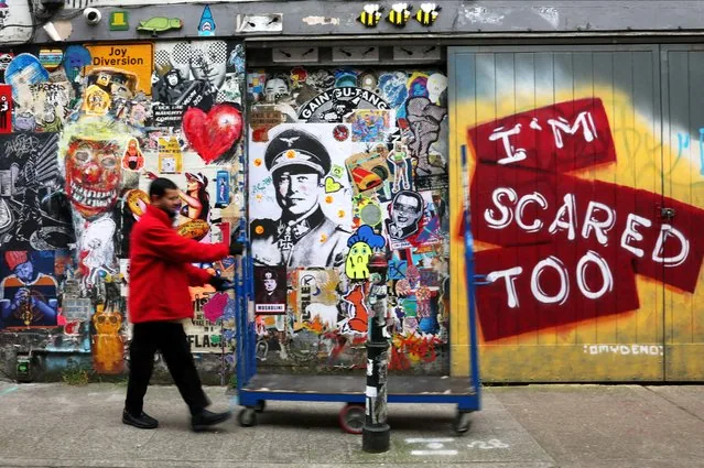 Street art posters of Elon Musk in Nazi uniform on Brick Lane east London March 2025