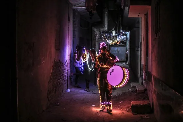 Mohammed Al-Dahshan on LED-decorated horse performing Ramadan drumming in Cairo Egypt