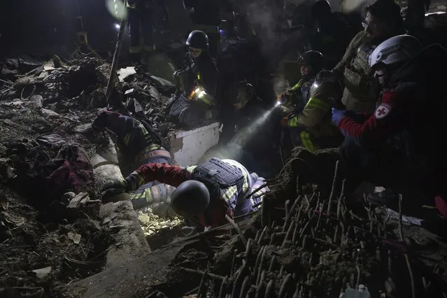 Rescue workers clearing rubble after Russian drone strike on residential house in Zaporizhzhia
