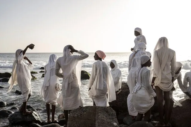 Layene brotherhood followers in white robes gather near sacred grotto in Ngor Senegal