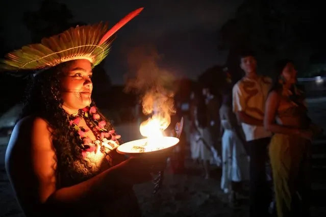 Indigenous woman holds smoking pot at Cine Aldeia inauguration in Manaus Brazil