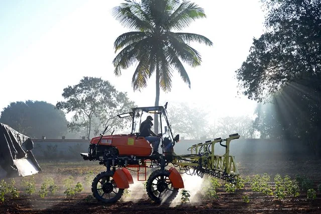 Workers at Niqo Robotics testing AI-powered spot sprayer on tractor near Bengaluru India