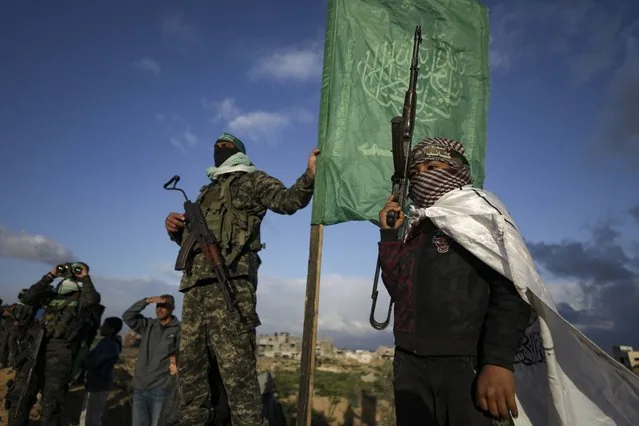 Boy stands beside Hamas fighter before handing over bodies to Red Cross Khan Younis Gaza