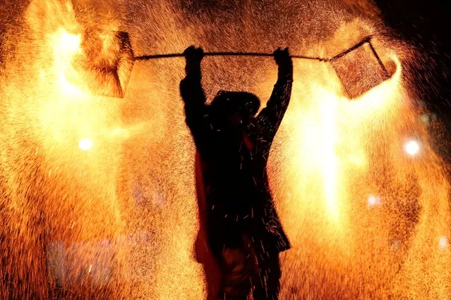 Folk artist performing molten iron fireworks at Shanghai Lantern Festival 2025