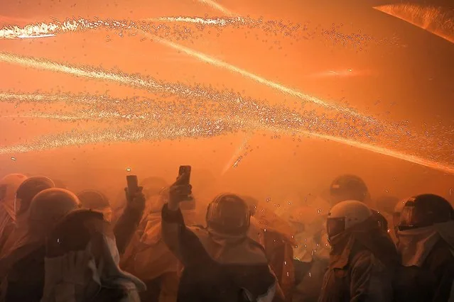 Festival-goers in protective gear during Yanshui Beehive Fireworks Festival in Taiwan
