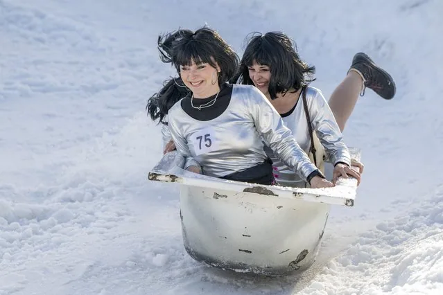 Costumed participant sliding downhill in bathtub during 11th Bathtub Race Stoos Switzerland