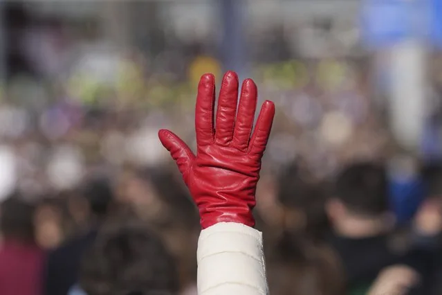 Woman raises red glove at Belgrade protest over train station canopy collapse deaths