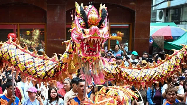 Dragon dancers perform on a street in Manila Chinatown on Lunar New Year 2025
